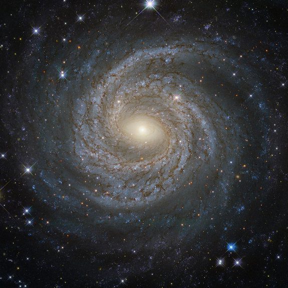“If confirmed by further experiments, this discovery of a possible fifth force would completely change our understanding of the universe,” says UCI professor of physics & astronomy Jonathan Feng, including what holds together galaxies such as this spiral one, called NGC 6814. ESA/Hubble & NASA; Acknowledgement: Judy Schmidt Spiral galaxies together with irregular galaxies make up approximately 60% of the galaxies in the local Universe. However, despite their prevalence, each spiral galaxy is unique Ñ like snowflakes, no two are alike. This is demonstrated by the striking face-on spiral galaxy NGC 6814, whose luminous nucleus and spectacular sweeping arms, rippled with an intricate pattern of dark dust, are captured in this NASA/ESA Hubble Space Telescope image. NGC 6814 has an extremely bright nucleus, a telltale sign that the galaxy is a Seyfert galaxy. These galaxies have very active centres that can emit strong bursts of radiation. The luminous heart of NGC 6814 is a highly variable source of X-ray radiation, causing scientists to suspect that it hosts a supermassive black hole with a mass about 18 million times that of the Sun. As NGC 6814 is a very active galaxy, many regions of ionised gas are studded along Êits spiral arms. In these large clouds of gas, a burst of star formation has recently taken place, forging the brilliant blue stars that are visible scattered throughout the galaxy. Image credit: ESA/Hubble & NASA; Acknowledgement: Judy Schmidt Text credit: European Space Agency