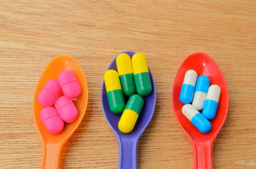 colorful medicine capsule pill on spoon